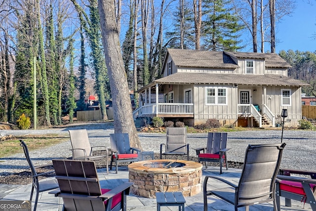 view of patio / terrace with an outdoor fire pit and fence