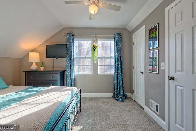 bedroom with visible vents, a ceiling fan, baseboards, carpet flooring, and lofted ceiling