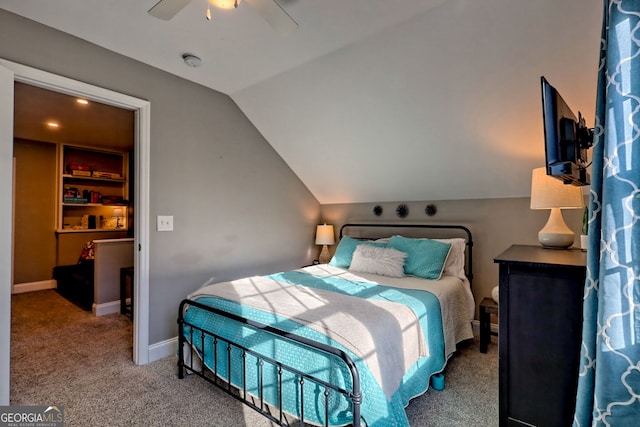 carpeted bedroom with ceiling fan, baseboards, and vaulted ceiling