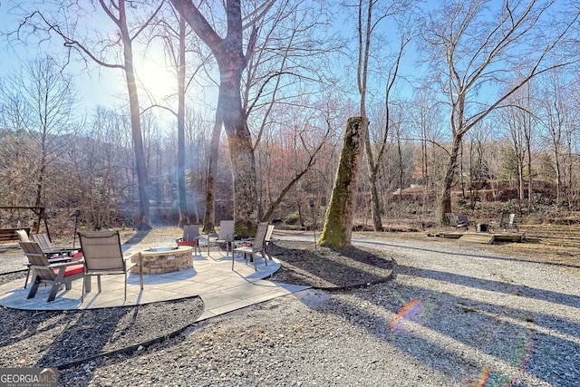 view of yard featuring a fire pit and a patio area