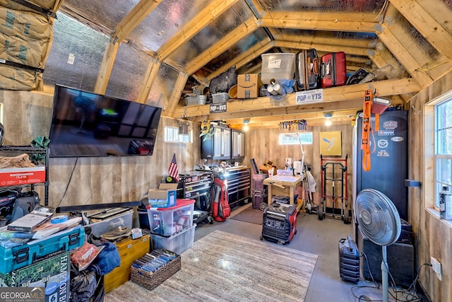 living area with finished concrete floors, wood walls, and lofted ceiling