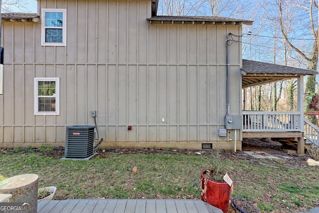 wooden deck featuring central AC unit