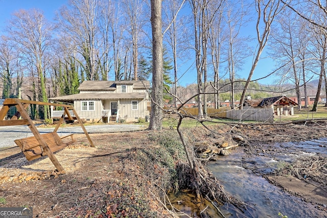 rear view of house featuring crawl space and board and batten siding