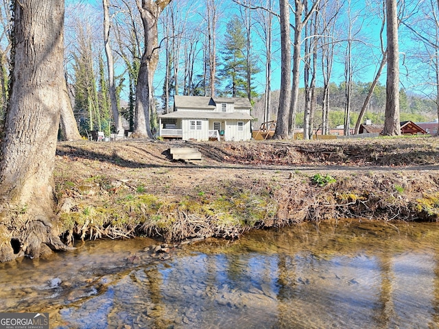 back of house featuring a water view