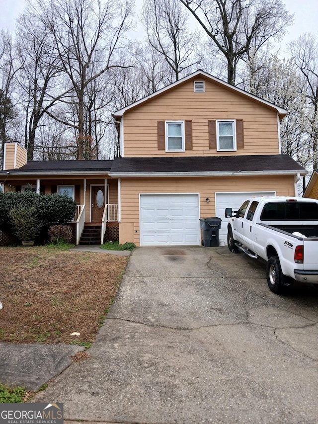 tri-level home featuring aphalt driveway and an attached garage