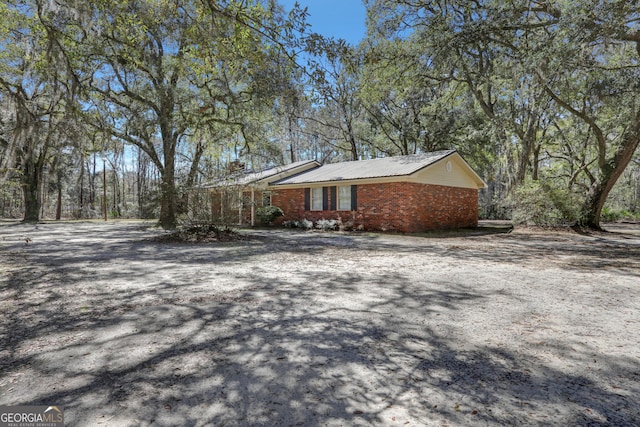 view of side of property with brick siding