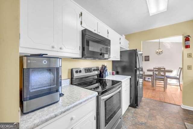 kitchen with black appliances, baseboards, light countertops, a notable chandelier, and white cabinetry