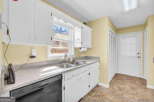 kitchen featuring a sink, dishwasher, white cabinets, and light countertops