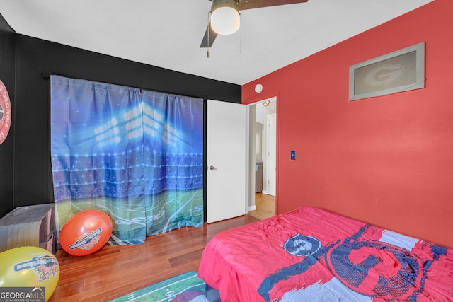 bedroom with a ceiling fan and wood finished floors