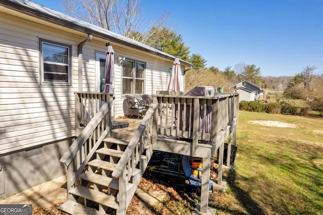 view of exterior entry with crawl space, a wooden deck, and a lawn