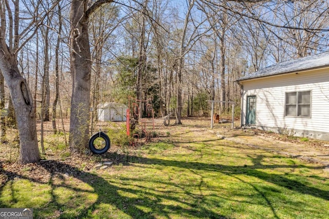 view of yard with an outbuilding and a storage shed