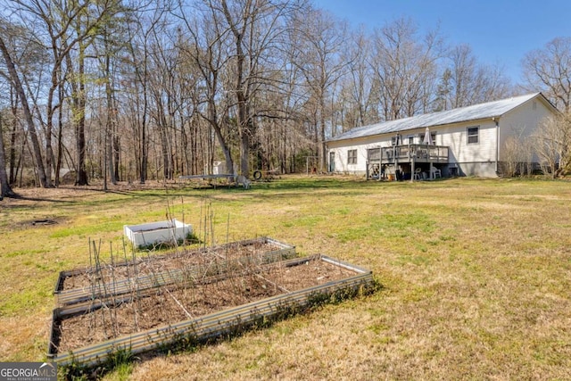 view of yard featuring a deck and a garden