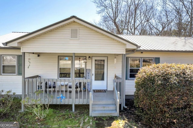 view of front of house featuring a porch and metal roof