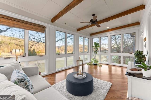 sunroom featuring beam ceiling and ceiling fan