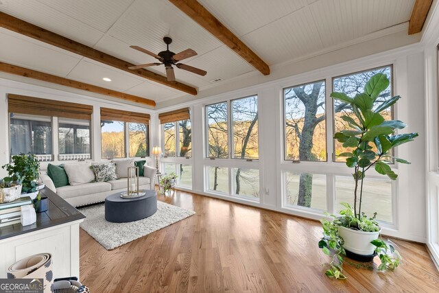 sunroom / solarium with beam ceiling and ceiling fan