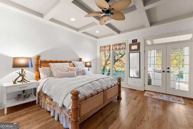 bedroom featuring french doors, wood finished floors, coffered ceiling, and access to outside