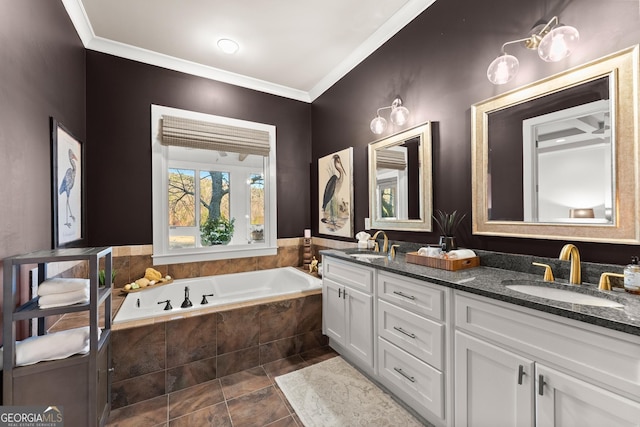 full bath with ornamental molding, a garden tub, and a sink