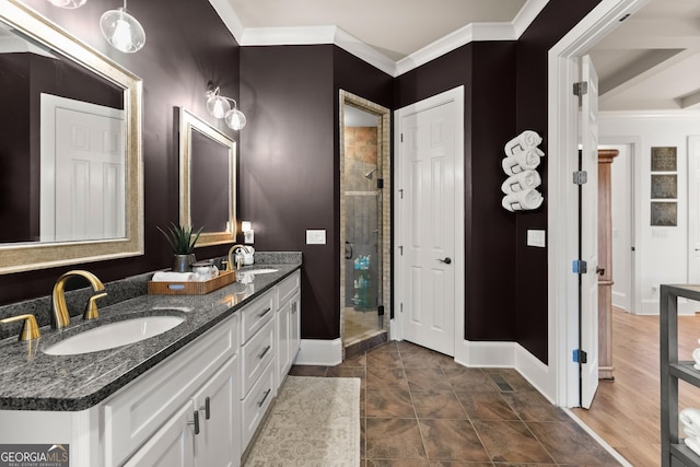 bathroom with crown molding, baseboards, and a sink