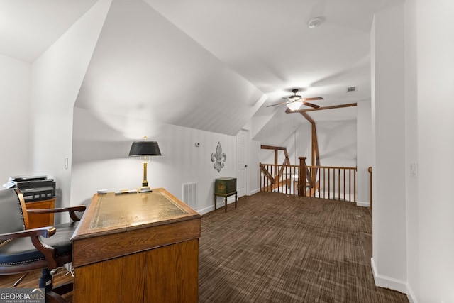 office space featuring baseboards, visible vents, lofted ceiling, ceiling fan, and dark colored carpet