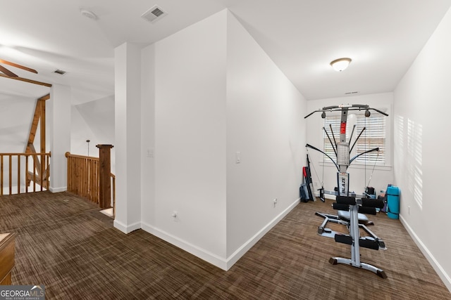 exercise room featuring visible vents, baseboards, ceiling fan, and carpet floors