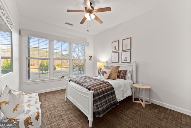 bedroom featuring visible vents, baseboards, a ceiling fan, and carpet flooring