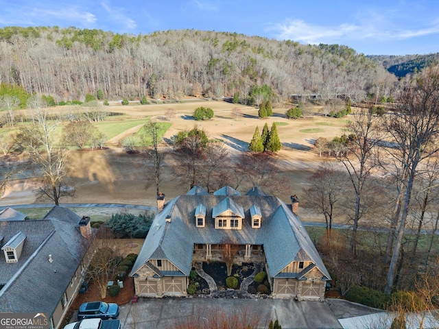 aerial view featuring a wooded view