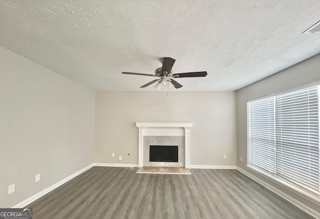 unfurnished living room featuring wood finished floors, a fireplace, and baseboards