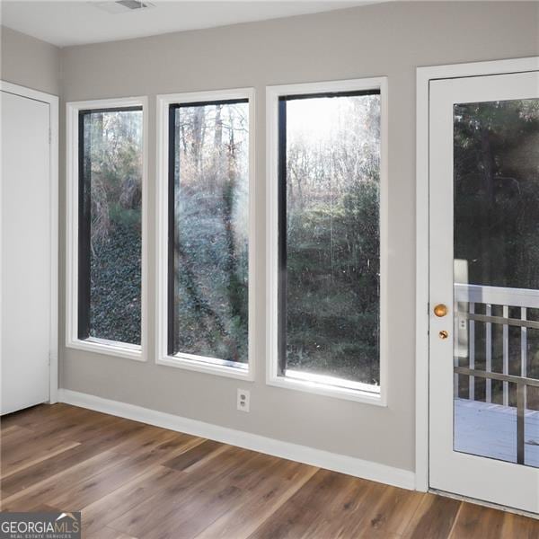 entryway with baseboards and wood finished floors