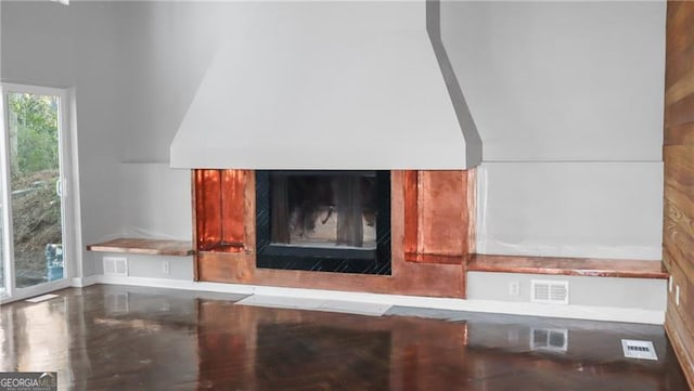 interior details featuring visible vents and a glass covered fireplace