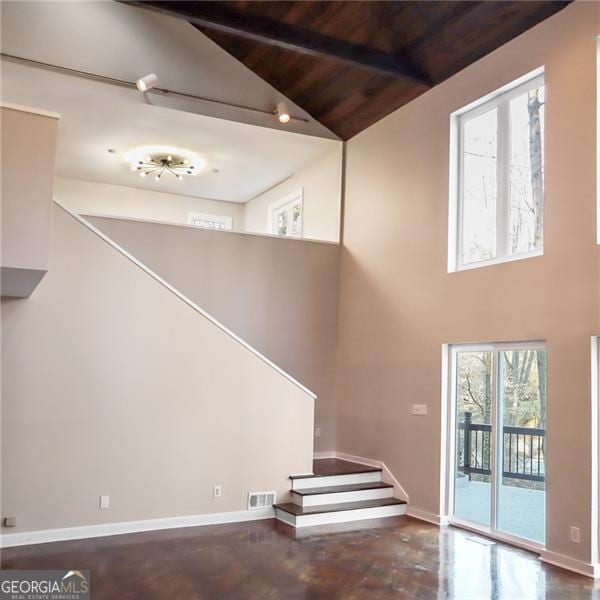 stairway with baseboards, visible vents, high vaulted ceiling, wooden ceiling, and beamed ceiling