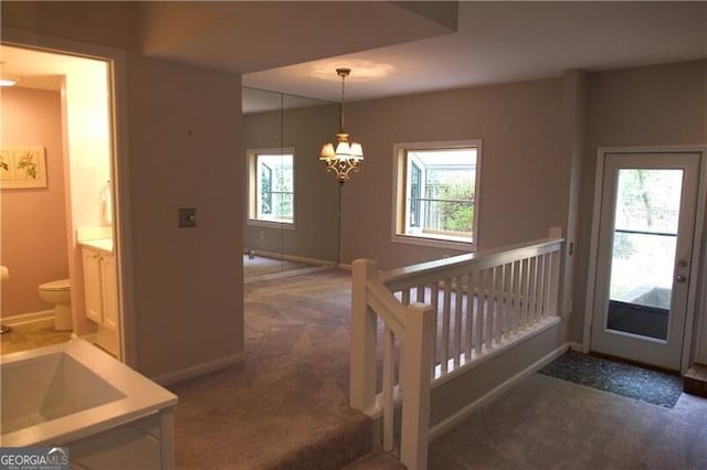 interior space featuring baseboards and carpet