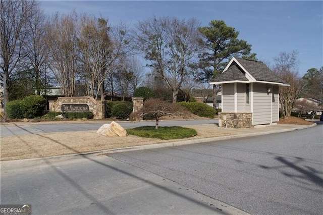 view of front of property featuring stone siding and a shingled roof