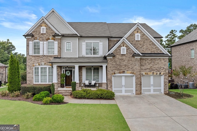 view of front of property with cooling unit, covered porch, concrete driveway, a front yard, and brick siding