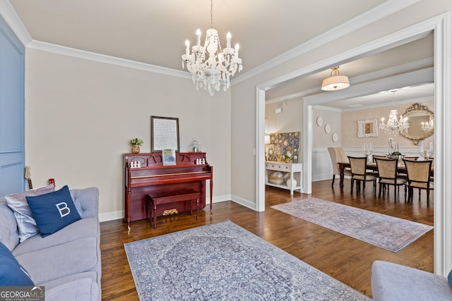 living room featuring a chandelier, dark wood-style floors, baseboards, and ornamental molding