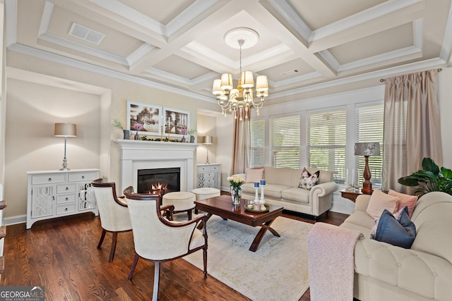 living room featuring a glass covered fireplace, a notable chandelier, dark wood-style floors, and visible vents