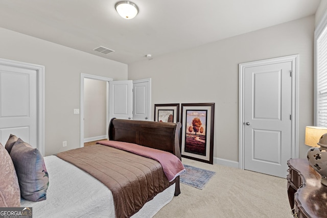 bedroom with visible vents, baseboards, and light colored carpet