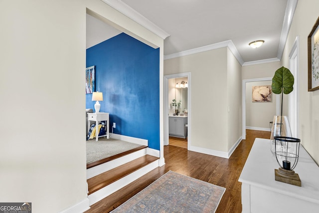 interior space featuring crown molding, wood finished floors, and baseboards