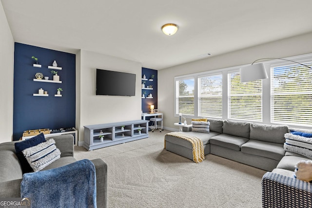 carpeted living area with baseboards