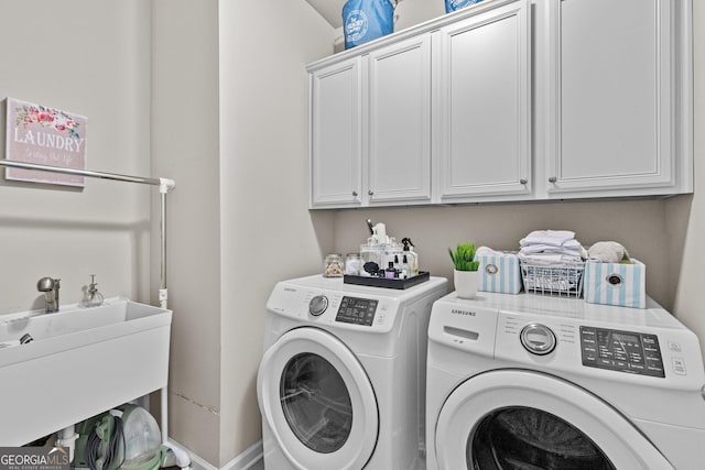 laundry room featuring a sink, cabinet space, and washing machine and dryer