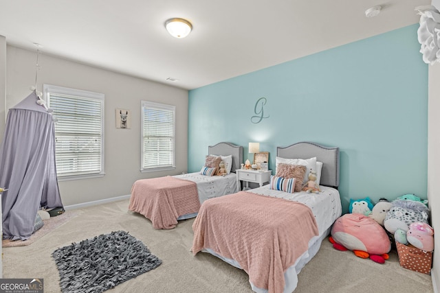 carpeted bedroom featuring visible vents and baseboards