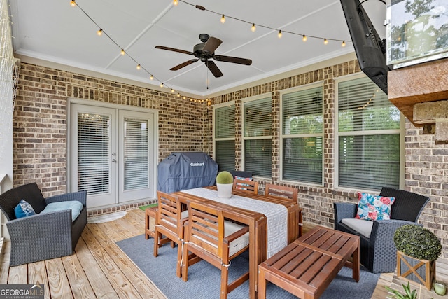 wooden deck featuring area for grilling, french doors, and ceiling fan