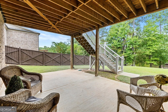 view of patio / terrace with stairs and fence