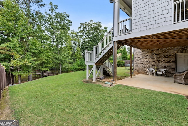 view of yard featuring stairs, a patio, and fence