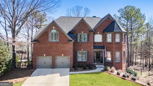 view of front of home featuring brick siding, driveway, a shingled roof, and a garage