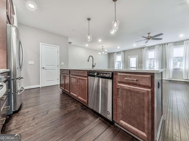 kitchen with a sink, stainless steel appliances, dark wood-type flooring, and recessed lighting