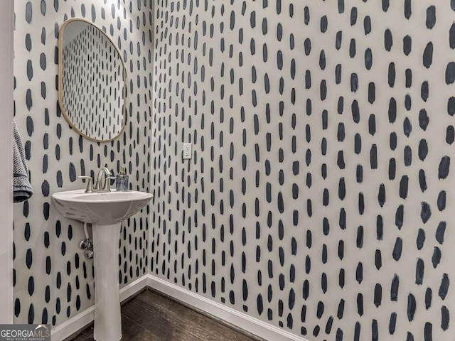 bathroom with wood finished floors and baseboards