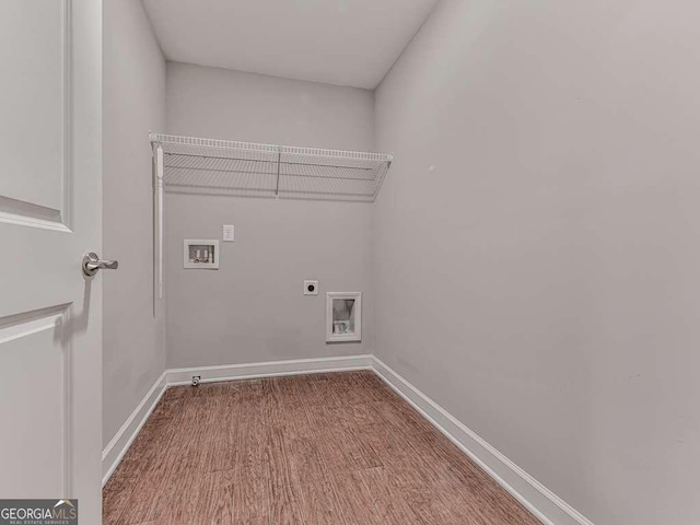 washroom featuring electric dryer hookup, wood finished floors, baseboards, hookup for a washing machine, and laundry area