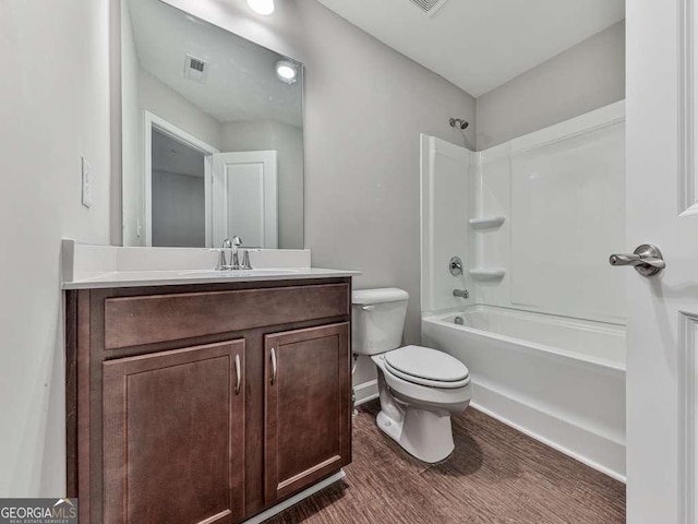 full bathroom featuring visible vents, toilet, shower / bath combination, wood finished floors, and vanity