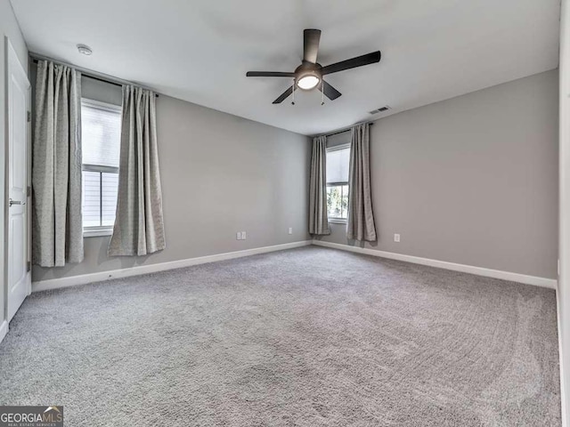 unfurnished room featuring baseboards, visible vents, and carpet floors