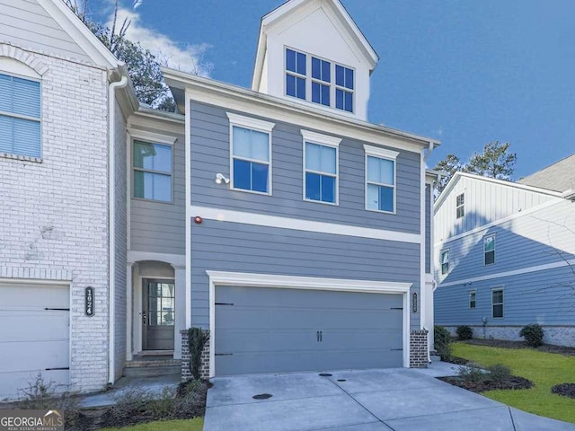 view of front of house featuring concrete driveway, an attached garage, and brick siding